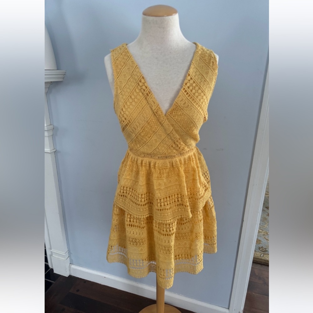 Crochet lace dress w/ tiered skirt & faux wrap crossover bodice in gold by Miami